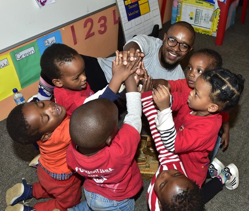 Add Hope ambassador Sthembiso Khosa playing with children at Africa Tikkun in Alexandra.