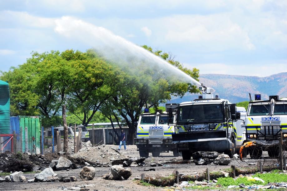 Striking mine workers in confrontation with police use rocks to barricade the roads leading to an informal settlement near Jabula mine shaft. The miners are demanding R16?500 a month from Anglo American Platinum. Picture: Leon Sadiki/City Press