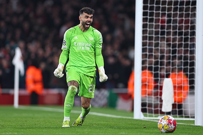 Arsenal goalkeeper David Raya celebrates after saving a penalty during the Champions League round of 16 second leg match against Porto at the Emirates Stadium on 12 March 2024. (Photo by Robbie Jay Barratt - AMA/Getty Images)