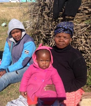 From left Zifikile, 20, Sivise, 1 and Noseven, 75, sit next to a sheep kraal in Mkhathazo in Mqanduli. The family are anxious about the job cuts in the mining sector. Picture: Lubabalo Ngcukana/City Press 