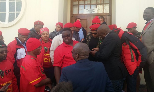 EFF leadership standing outside Court D at
the Polokwane High Court ahead of their leader's appearance.

