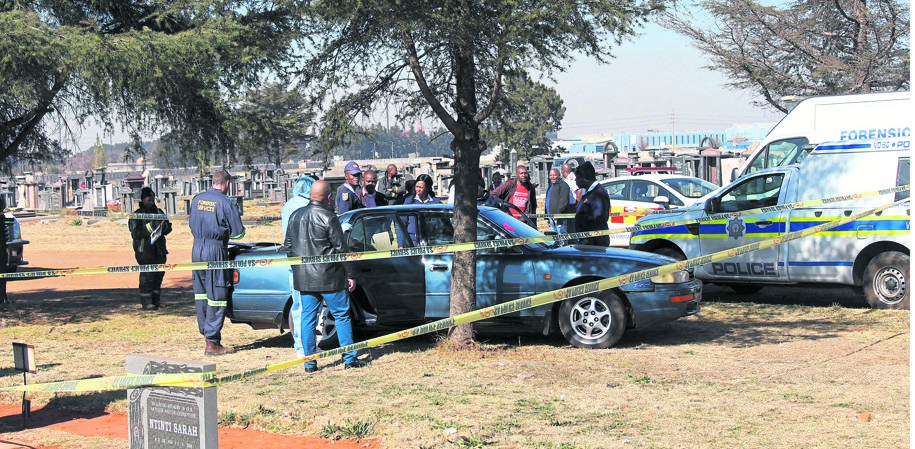 Cops at the scene in Vanderbijlpark Cemetery, where a man and his girlfriend were found shot dead on Friday morning.   Photo by Sifiso Jimta