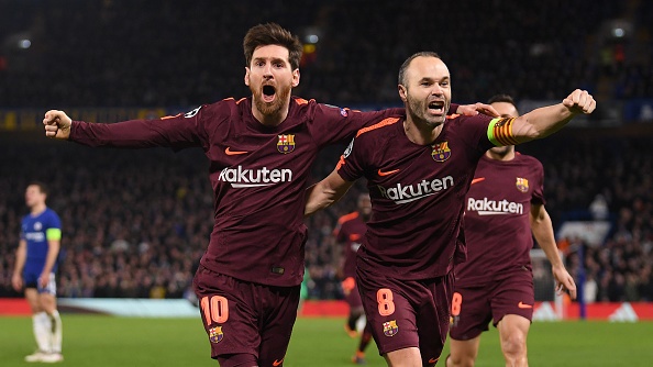 Lionel Messi of Barcelona celebrates his equaliser with team mate Andres Iniesta 