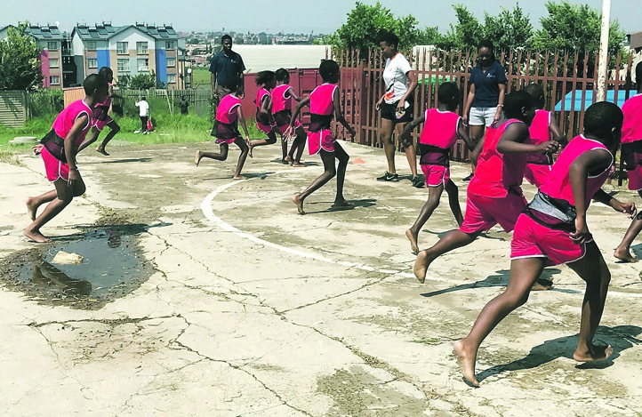 Children at Lukholweni Primary School, from Soweto, playing while exercising. 