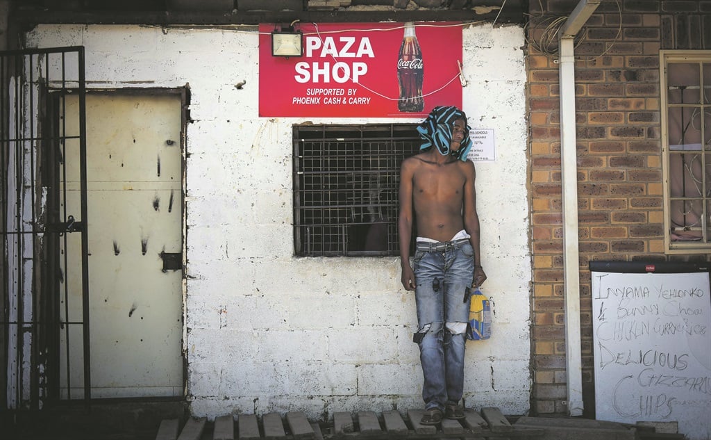 An Orabi resident stands near a Spaza Shop in the village. photo. Jonathan Burton. Picture: Lucky Nxumalo