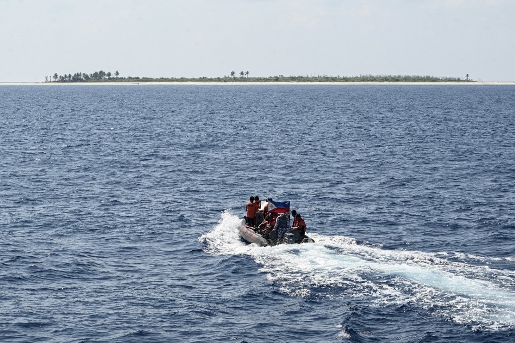 Philippine coast guard personnel onboard their rigid hull inflatable boat sailing towards the Philippine-occupied West York island in the disputed South China Sea.