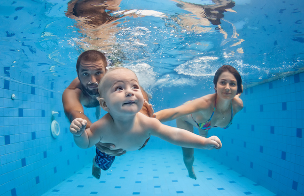 family swimming in pool