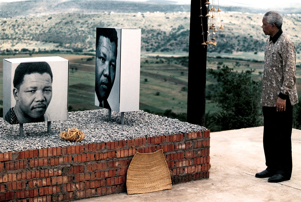  Nelson Mandela walks past photos of himself at Qunu’s open air museum in his honour. Picture: Christiaan Kotze