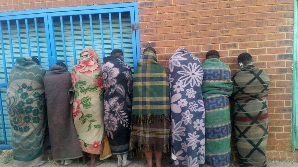WRAPPED UP: These girls huddling in their blankets were rescued before possibly being harmed.