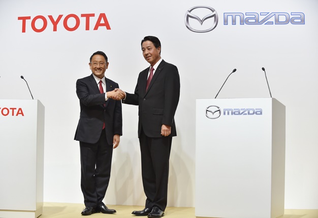 <b> JOINING FORCES: </b> Toyota Motor Corporation President Akio Toyoda (L) shakes hands with Mazda Motor Corporation President and CEO Masamichi Kogai (R). <i> Image: AFP / Kazuhiro Nogi </i>    