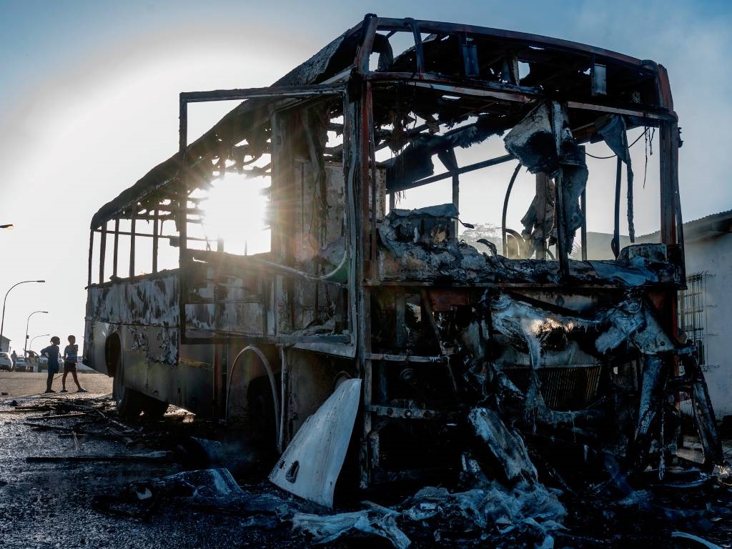 A burnt Golden Arrow bus is seen that was set on fire by protesters in in Cape Town.