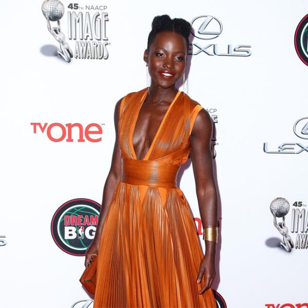 lupita orange dress We Love Lupita Nyong'o's Fishtail Loc Updo at the Oscars 2022