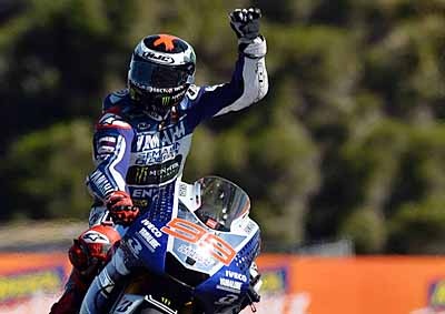 <b>LORENZO LAPS UP PRAISE:</b> Yamaha's Jorge Lorenzo acknowledges the crowd's cheers after taking pole position for the start of the 2013 Australian MotoGP on Phillip Island. <i>Image: AFP</i>