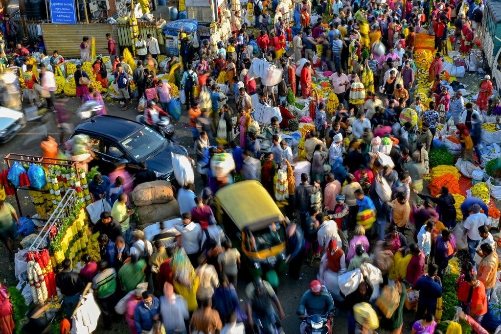 People walking through a market in Bangalore on 23 October 2022. According to the UNFPA, it took 12 years for the world's population to grow from 7 billion to 8 billion.