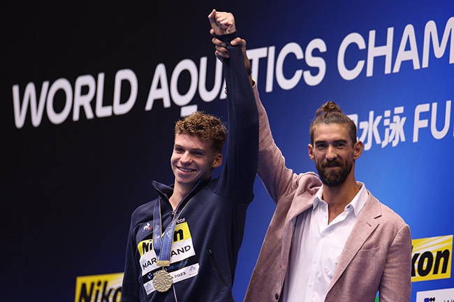 Leon Marchand of Team France is congratulated by Michael Phelps. (Photo by Adam Pretty/Getty Images)