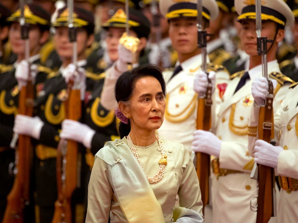 Myanmar's State Counselor Aung San Suu Kyi reviews an honor guard during a welcome ceremony at the Great Hall of the People in Beijing, Thursday, Aug. 18, 2016.