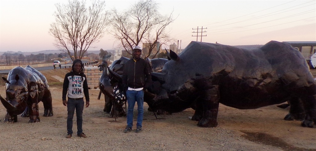 Patrick Chipangula (left) and Adolf Moyo (right) say you can’t miss their huge metal rhinos for sale in Harrismith. Photo by Jim Mokoena