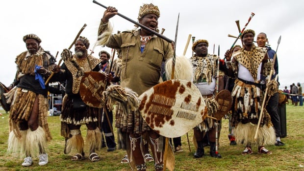 Zulu men dressed in their traditional war outfits at the Battle of Blood River Heritage site