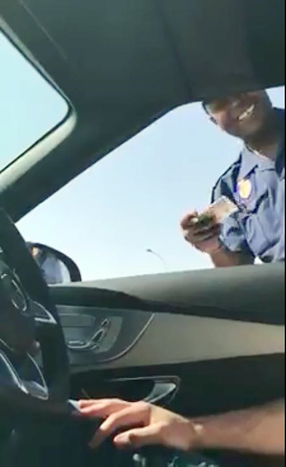 A video screengrab shows a fascinated Metro cop talking to the driver of the Merc.