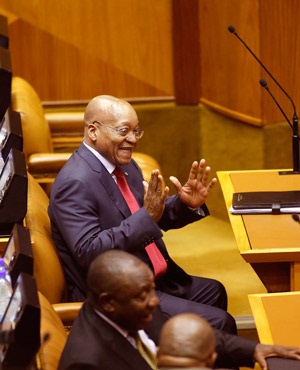 Former president Jacob Zuma enjoys a light moment in the National Assembly of Parliament in 2015. (AFP)