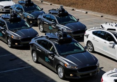 <b>UBER'S DRIVERLESS FUTURE:</b> A fleet of self-driving Ford Fusions picked-up journalists as part of a test program in September 2016. <i>Image: AP / Gene J. Puskar</i>