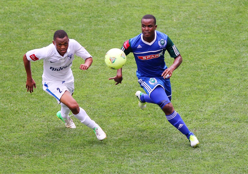 DURBAN, SOUTH AFRICA - DECEMBER 09, Katleo Pule (l) and Stanley Kgatla chase a loose ball  during the Absa Premiership match between AmaZulu and Bidvest Wits from Moses Mabhida Stadium on December 09, 2012 in Durban, South Africa