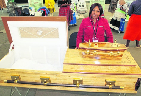 Modiehi Motaung with some of the coffins she and her co-operative make and sell in QwaQwa.              Photo by Dan Xangaza