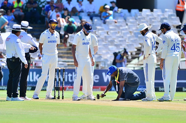 A member of Newlands' groundstaff attends to a hitch on the pitch. 