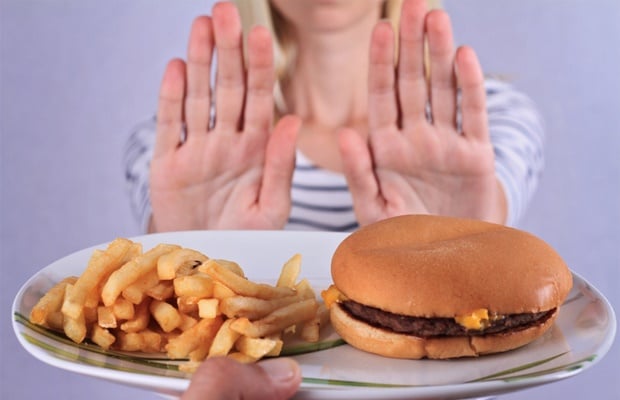 Woman saying no to junk food