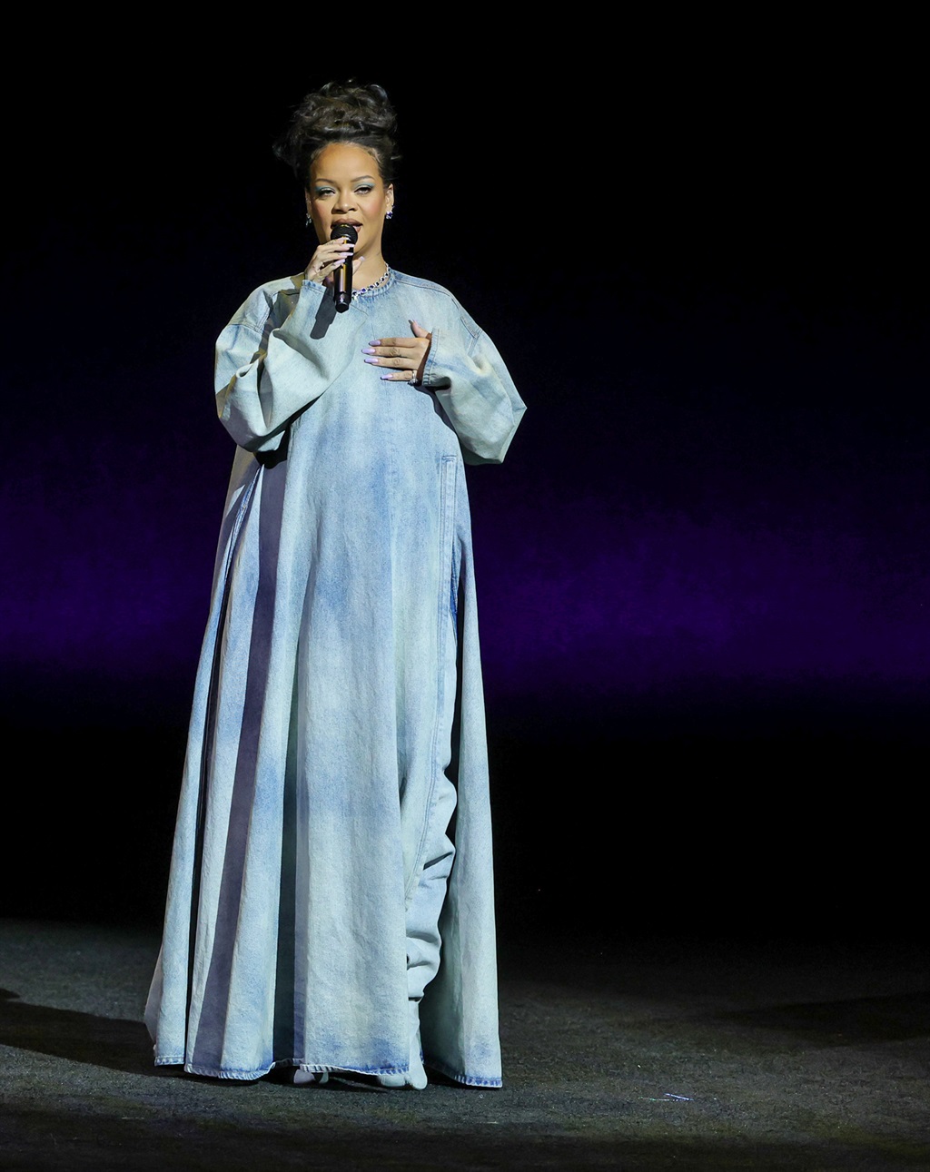 Rihanna speaks onstage as she promotes the upcomin