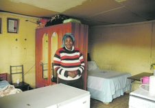 Andiswa Patros and her husband have no privacy in the RDP they share with their daughters.            Photo by Chris Qwazi