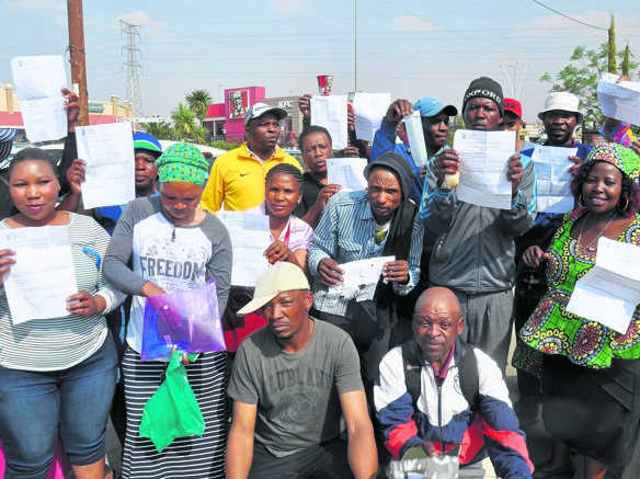 Lesotho citizens outside Home Affairs with their permit rejection letters. Photo by Kabelo Tlhabanelo
