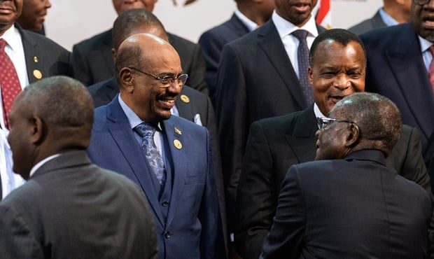 Sudan President Omar al-Bashir is greeted by AU Chairperson and Zimbabwean President Robert Mugabe during a group photograph at the 25th AU Summit in Johannesburg. (Gianluigi Guercia, AFP)