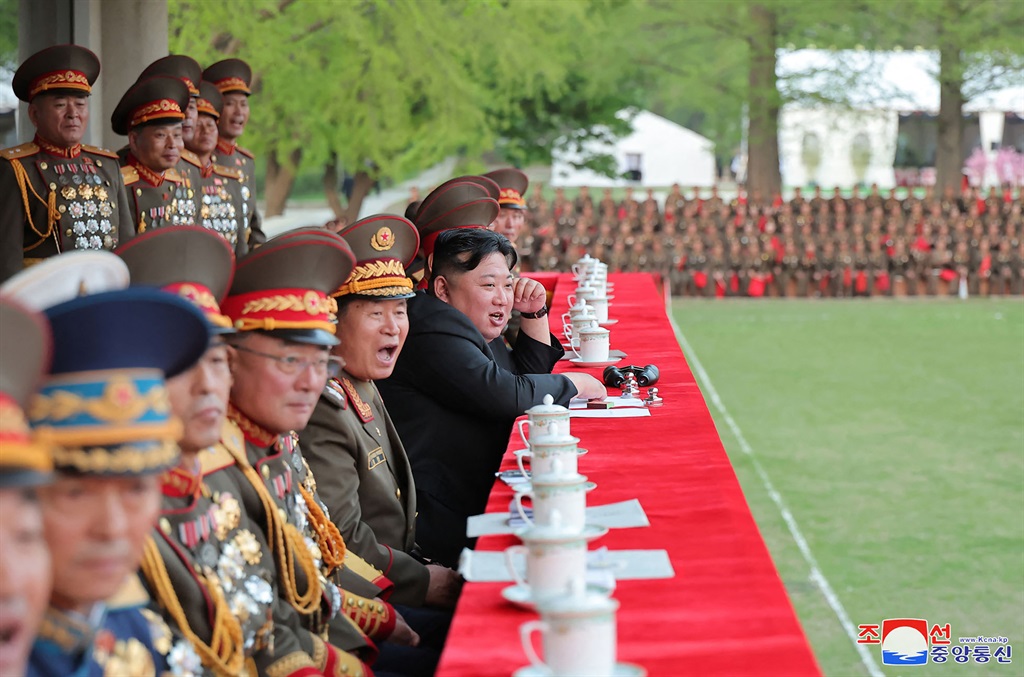 This picture taken on 25 April 2024 and released by North Korea's official Korean Central News Agency (KCNA) via KNS on 26 April 2024, shows North Korea's leader, Kim Jong Un (C), watching a football match as he pays a visit to Kim Il Sung Military University in Pyongyang to mark the 92nd anniversary of the founding of North Korea's army. (KCNA via KNS / AFP)