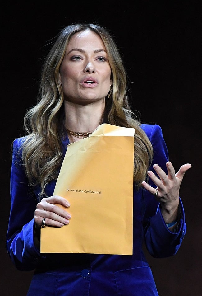 US director and actress Olivia Wilde holds an enve