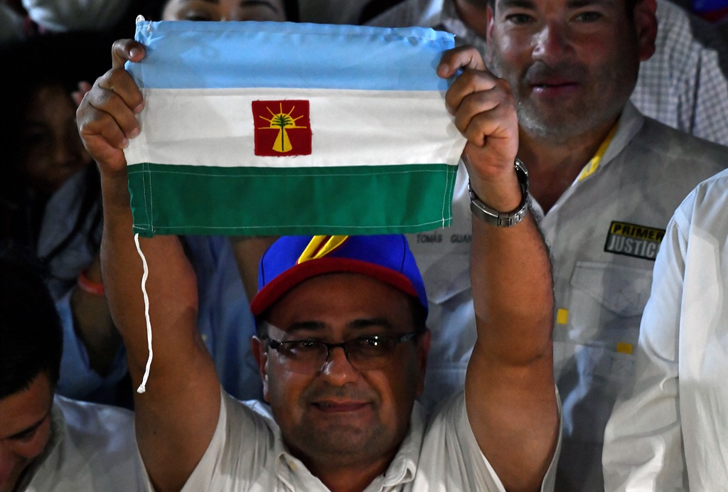 The opposition candidate for governor of the state of Barinas, Sergio Garrido holds a flag of the state of Barinas, during a press conference on the gubernatorial election in the city of Barinas, Venezuela, on January 09, 2022. 
Federico Parra / AFP