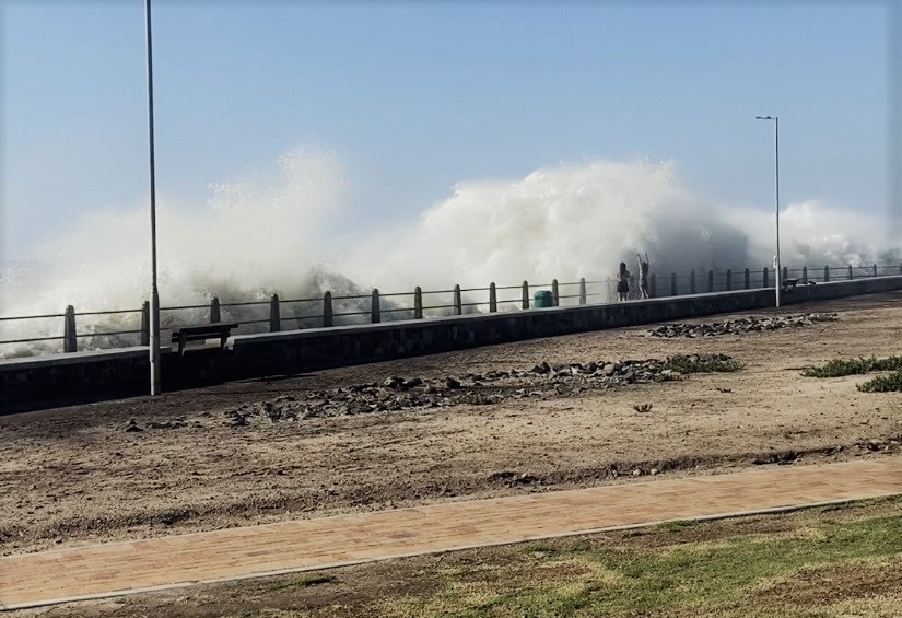 Waves driven by strong winds and the spring tide hit the Sea Point promenade. (Photo: News24)