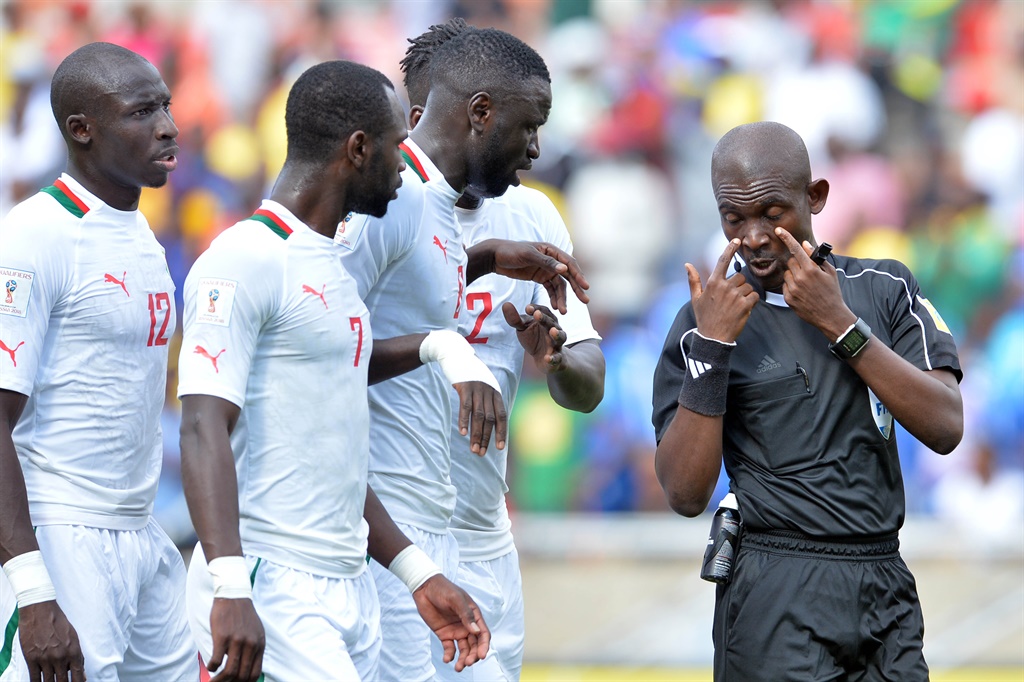 Angry Senegal players wanted to throttle referee Joseph Lamptey for awarding a dubious penalty 