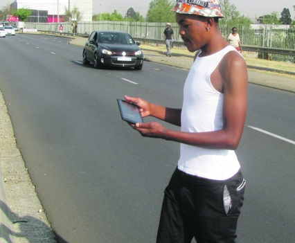 Texting while crossing a road can get you killed. Photo by Kopano Mohaheng