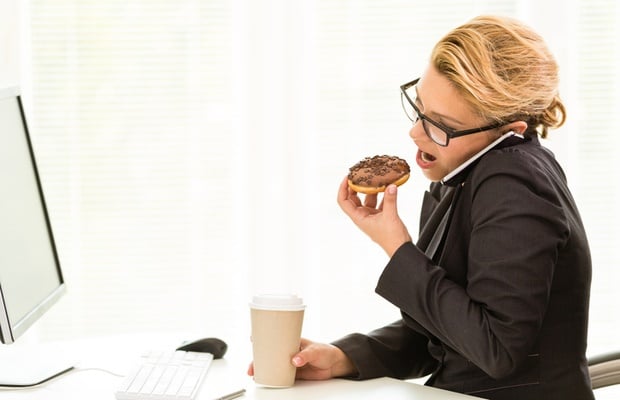 woman stress-eating at her desk