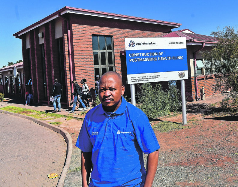 Keaobaka Matilo stands in front of the Postmasburg Clinic sponsored by Kumba Iron Ore.  Photo by   Themba Makofane