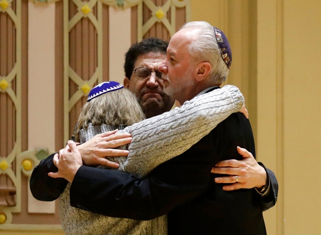 Rabbi Jeffrey Myers, right, of Tree of Life/Or L'Simcha Congregation hugs Rabbi Cheryl Klein, left, of Dor Hadash Congregation and Rabbi Jonathan Perlman during a community gathering. (Matt Rourke, AP)