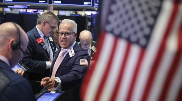 Traders and financial professionals work on the floor on the New York Stock Exchange. (Photo: Drew Angerer, AFP)