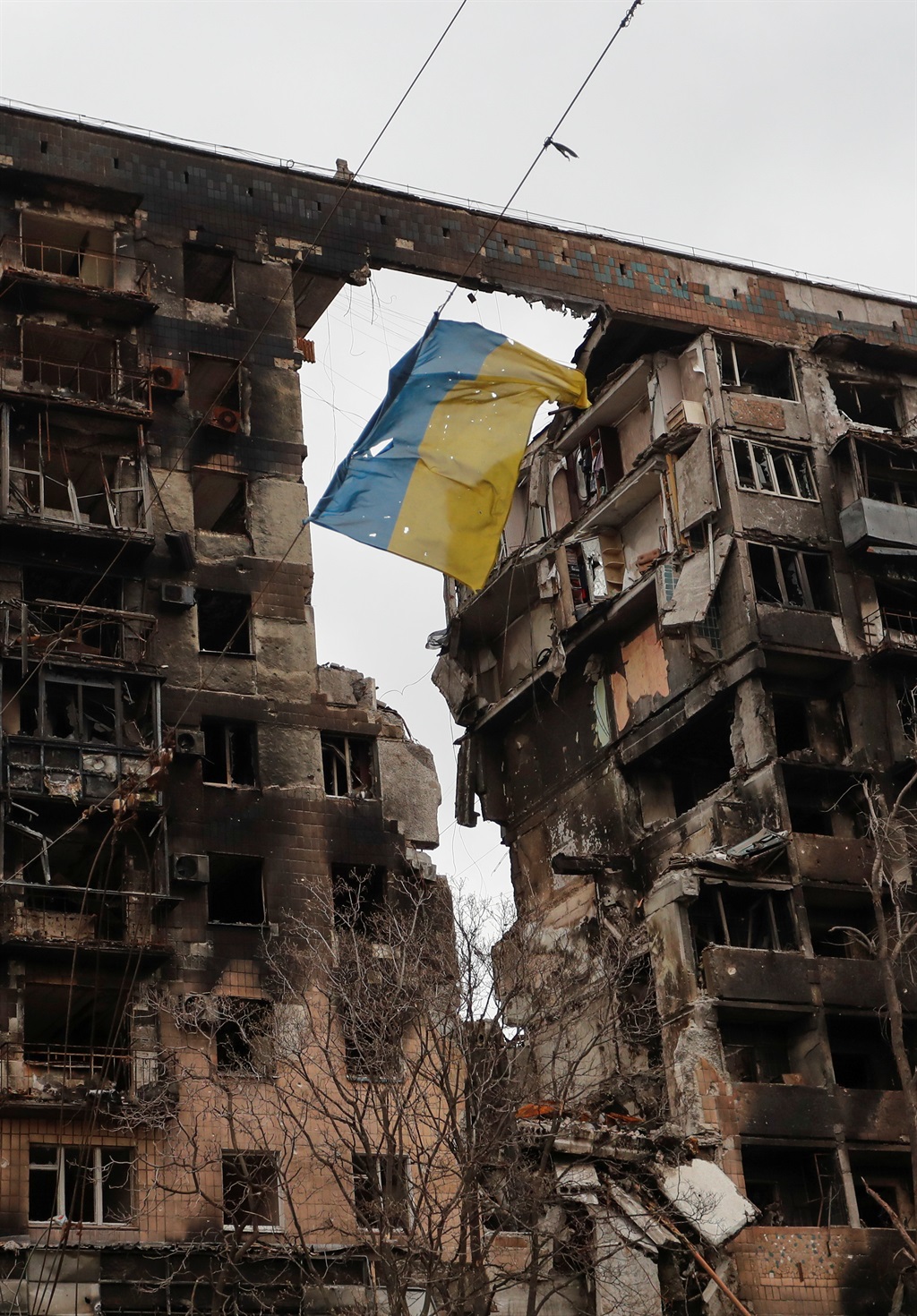 A view shows a torn flag of Ukraine hung on a wire