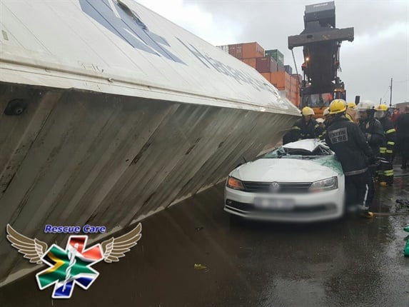 Rescue Care paramedics report that a policeman died and another person was injured when the container fell on the car on Rotterdam Road at the Durban Harbour.
