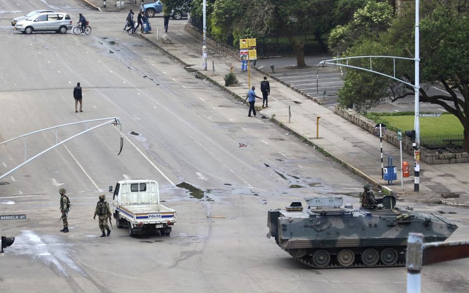 Armed soldiers patrol a street in Harare, Zimbabwe, Wednesday, Nov. 15, 2017. Zimbabwe's army said Wednesday it has President Robert Mugabe and his wife in custody and is securing government offices and patrolling the capital's streets following a night of unrest that included a military takeover of the state broadcaster. Picture: AP 

 
