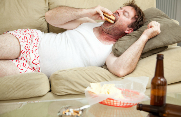 drunk man on couch eating fast food