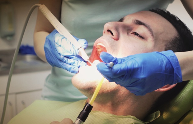 Man having his teeth professionally cleaned at the