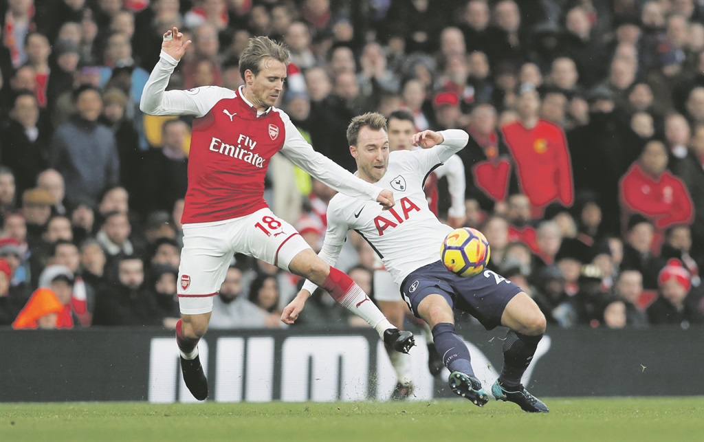 Hight flying: Arsenal’s Nacho Monreal fights for the ball with Tottenham’s Christian Eriksen in yesterday’s Premier League clash at the Emirates Stadium. Picture: David Klein / Reuters