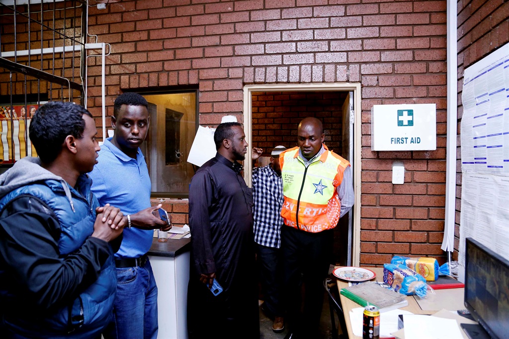 KZN MEC for the Department of Community Safety and Liaison Mxolisi Kaunda speaking to the owners of the supermarket who survived the shooting. Photo SuppliedPhoto Supplied